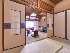 a room with sliding doors and a living room at Yamamoto Ryokan in Kyoto +27 photos