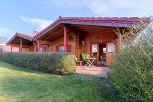 a log home with a porch and a patio at Grabner, Haus 2 in Ueckeritz