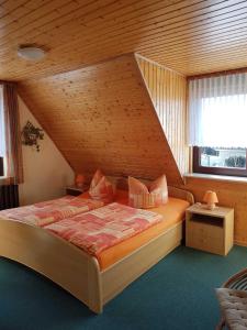 a bedroom with a bed with a wooden ceiling at FeWo " Anemone " in Ueckeritz +5 photos