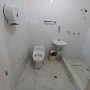 a bathroom with a toilet and a sink at INTERCULTURALITY LODGE Country House in Ollantaytambo