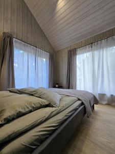 a bedroom with a large bed with a window at PUTNI Resort in Laukbeitini