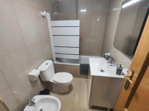 a small bathroom with a toilet and a sink at Garrucha Home in Garrucha