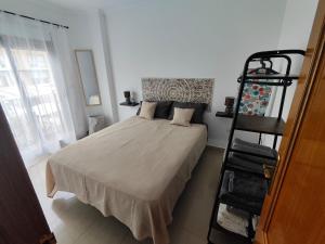 a bedroom with a bed and a ladder in it at Garrucha Home in Garrucha