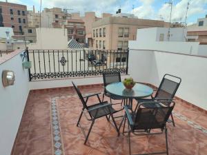 a patio with a table and chairs on a balcony at Garrucha Home in Garrucha