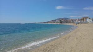 a sandy beach with buildings and the ocean at Ely Home in Garrucha