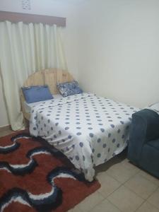 un letto con un piumone in una camera di Studio Space a Nairobi