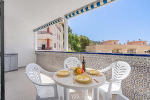 a white table and chairs on a balcony at Apto Mediterraneo 7 La Herradura in La Herradura