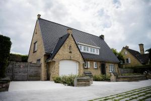 a large brick house with a white garage at Vakantievilla 3 Beaufort in Nieuwpoort