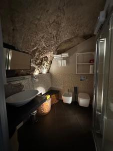 a bathroom with a sink and two toilets at CasaCastellett in Modica +19 photos