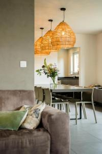 a living room with a couch and a table at Vakantievilla 3 Beaufort in Nieuwpoort