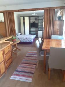a living room with a table and a bedroom at Sokol in Ogulin