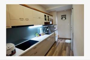 a kitchen with white cabinets and a counter top at N's house in Phan Thiet