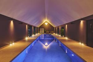 a swimming pool in the middle of a house with lights at The Suite in Glastonbury
