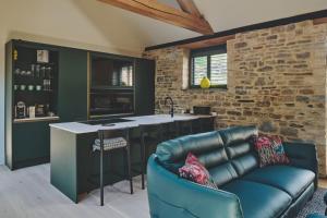 a kitchen with a leather couch and a kitchen island at The Suite in Glastonbury