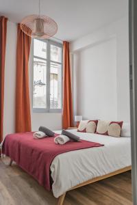 a bedroom with a large bed with red curtains at Le balcon du roi René in Avignon +16 photos