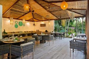 a restaurant with tables and chairs and a bar at Stone Wood Premier Dandeli in Dandeli