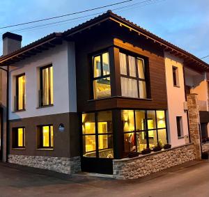 a house with many windows on a street at Azul Andrin in Andrín