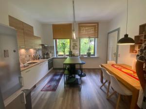 a kitchen with a table and a dining room at Sonneck in Bad Sachsa