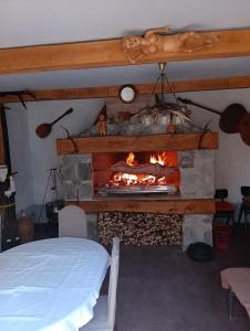 a fireplace in a bedroom with a bed and a fire place at Sokol in Ogulin