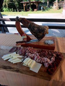 a cutting board with meats and cheese on a table at Sokol in Ogulin +13 photos