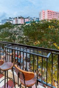 a balcony with chairs and a view of a city at Saigon Hideout New World View in Ho Chi Minh City