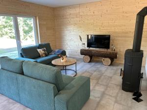 a living room with a couch and a wood stove at Ferienhaus Haselnuss in Schleiden