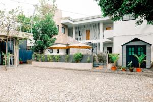 a house with a gravel driveway in front of it at Modern Luxury Villa with pool breakfast included in Bacolod