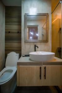 a bathroom with a sink and a toilet and a mirror at Modern Luxury Villa with pool breakfast included in Bacolod