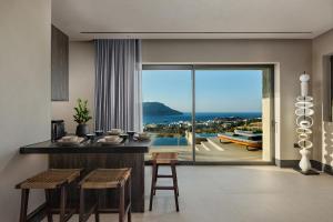 a kitchen with a counter and a view of the ocean at Omega Residences in Karpathos
