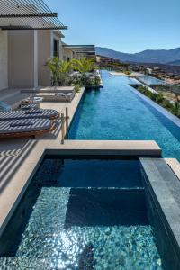 a swimming pool on the side of a house at Omega Residences in Karpathos +67 photos