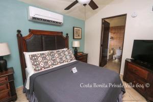 a bedroom with a bed and a flat screen tv at Costa Bonita Private Villas in Culebra