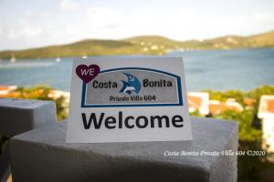 a sign that says welcome on top of a wall at Costa Bonita Private Villas in Culebra