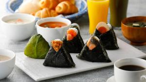 a plate of food with sushi and cups of coffee at Toyoko Inn Tokuyama-eki Kita-guchi in Shunan