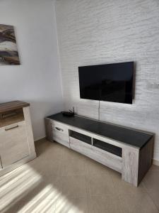 a living room with a flat screen tv on a wall at Appartement Sofia in Martil