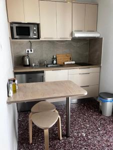 a small kitchen with a table and a sink at Star lounge in Preveza