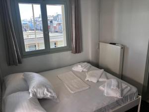 a bed in a room with a window at Star lounge in Preveza