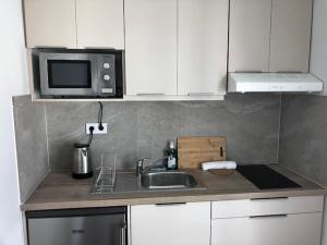 a kitchen with a sink and a microwave at Star lounge in Preveza