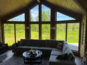 a living room with a couch and a table at Mitt paradis in Bardufoss