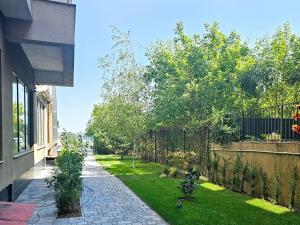 a backyard with a fence and a yard with plants at Lake House - Bucuresti in Bucharest