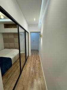 a bedroom with a bed and a glass wall at Zgoda 5 Apartment in Gdynia