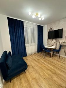 a living room with a couch and a table at Zgoda 5 Apartment in Gdynia