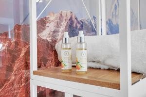 two bottles of hair products sitting on a shelf at Dartford Town 3 Bed by Harlington in Dartford