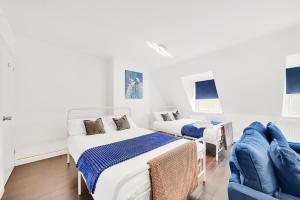 a white room with two beds and a couch at Dartford Town 3 Bed by Harlington in Dartford