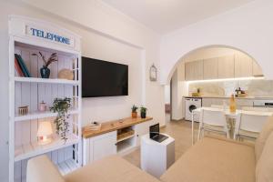 a living room with a tv and a dining room at Mailo&Luke apartments in Rhodes Town