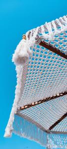 a close up of a mattress with a white blanket at PALAZZO CAVÌ in Mola di Bari +65 photos