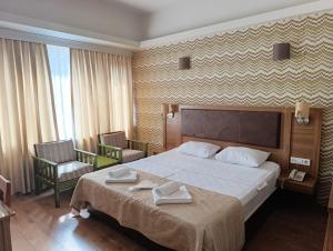 a hotel room with a large bed and two chairs at Grand As Hotel in Istanbul +66 photos