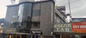 a building with a lot of windows in a city at XCELSIOR HOTEL AND SPA by ROH in Shillong