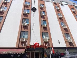 a building with a sign in front of it at Grand As Hotel in Istanbul