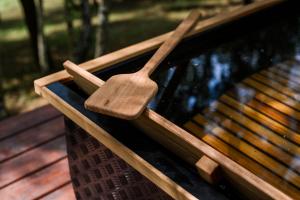 a wooden spoon sitting on top of a park bench at Bukowy Las in Lipnica Górna +19 photos