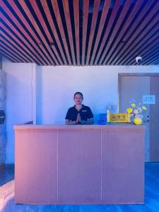 a man standing at a counter in a room at Jianpuke Space Capsule Backpacker Hostel in Sihanoukville +36 photos